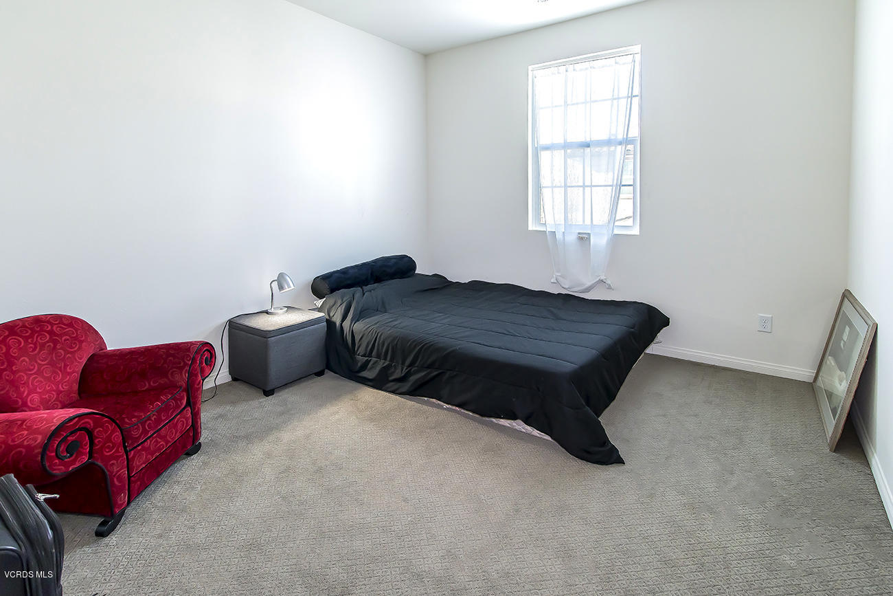 2464 Blossom Ridge Court, Unit 2 Simi Valley, CA 93063 - Photo 24 of 41 a room with a bed and a chair