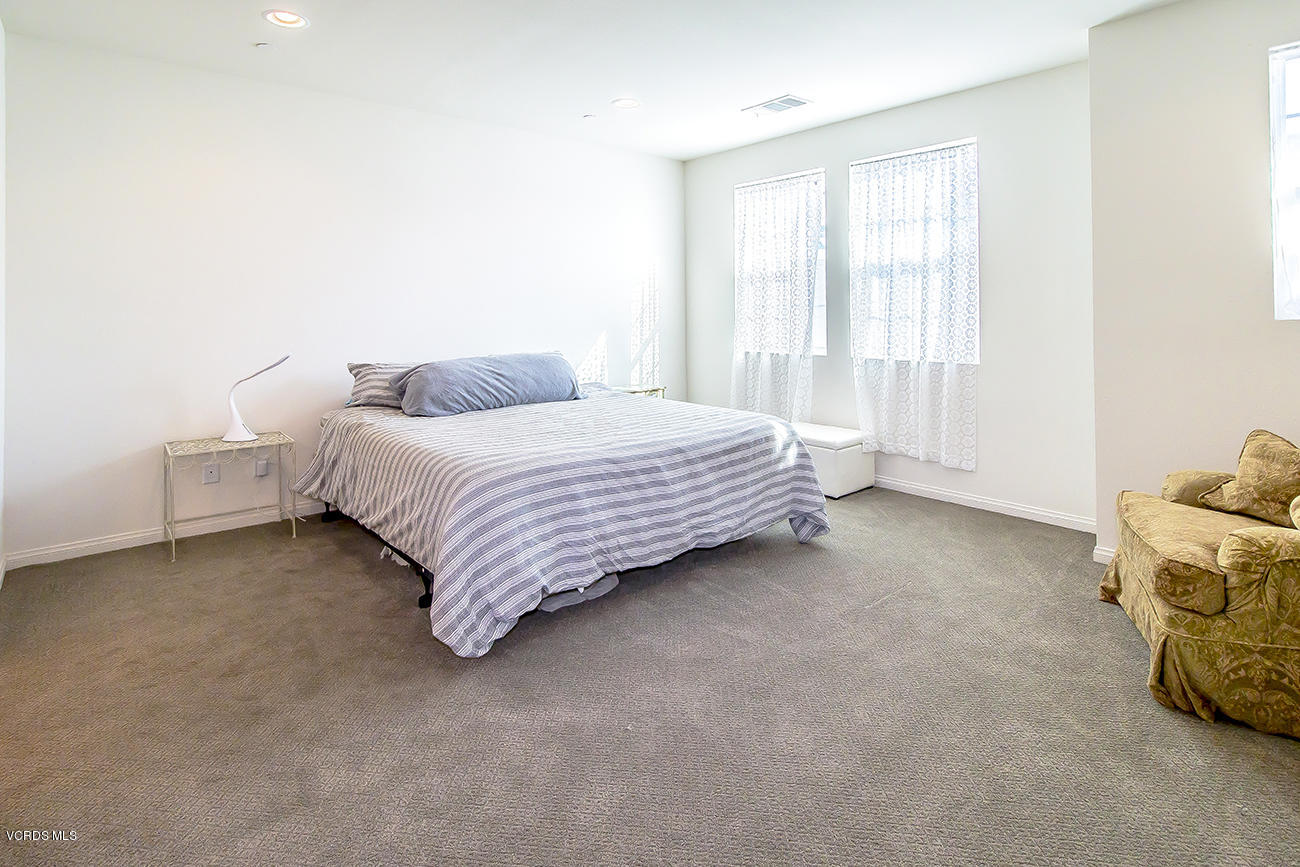 2464 Blossom Ridge Court, Unit 2 Simi Valley, CA 93063 - Photo 27 of 41 a spacious bedroom with a bed and a window