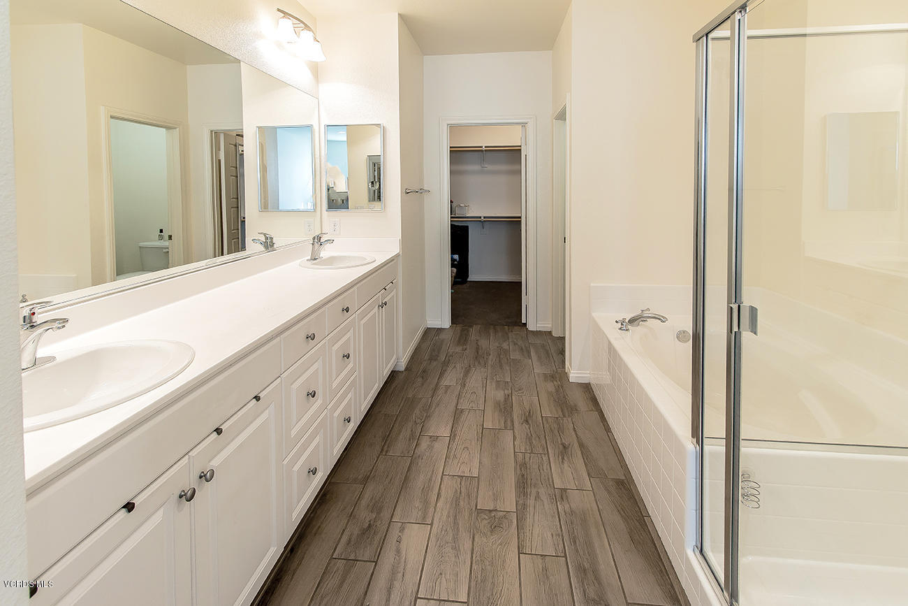 2464 Blossom Ridge Court, Unit 2 Simi Valley, CA 93063 - Photo 29 of 41 a spacious bathroom with a double vanity sink and a large mirror