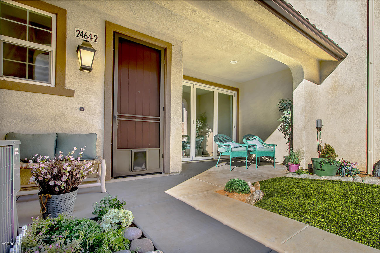 2464 Blossom Ridge Court, Unit 2 Simi Valley, CA 93063 - Photo 4 of 41 a front view of a house with a garden and patio