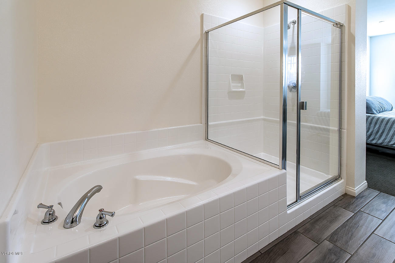 2464 Blossom Ridge Court, Unit 2 Simi Valley, CA 93063 - Photo 31 of 41 a bathroom with a bathtub and a shower