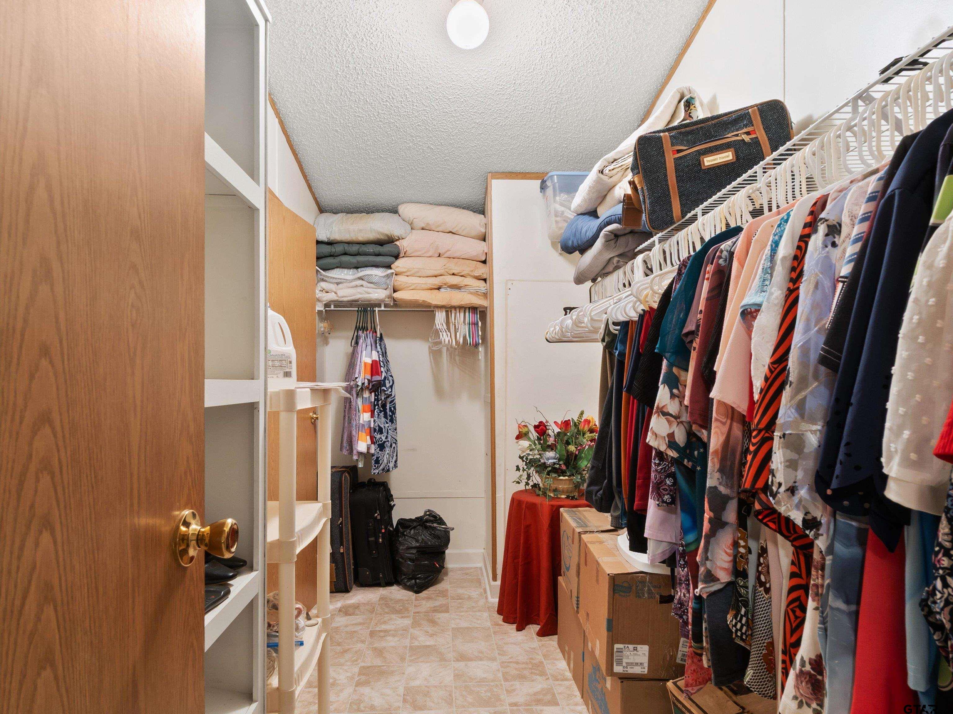 2811 Medlin Road Gilmer, TX 75645 - Photo 25 of 30 a view of walk in closet with clothes and shoes