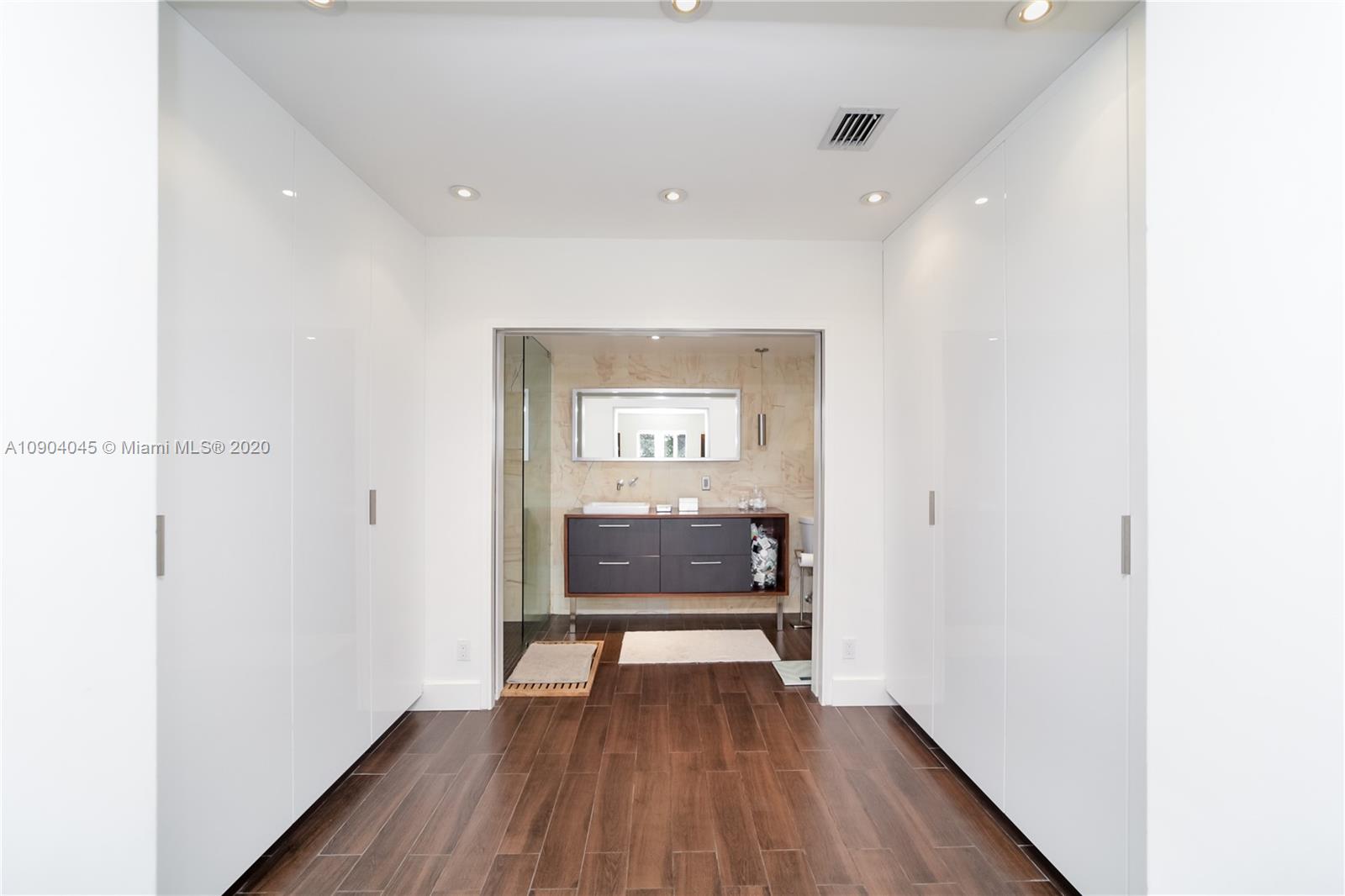 434 Southwest 30th Road Miami, FL 33129 - Photo 19 of 51 a view of a hallway with wooden floor and a bathroom