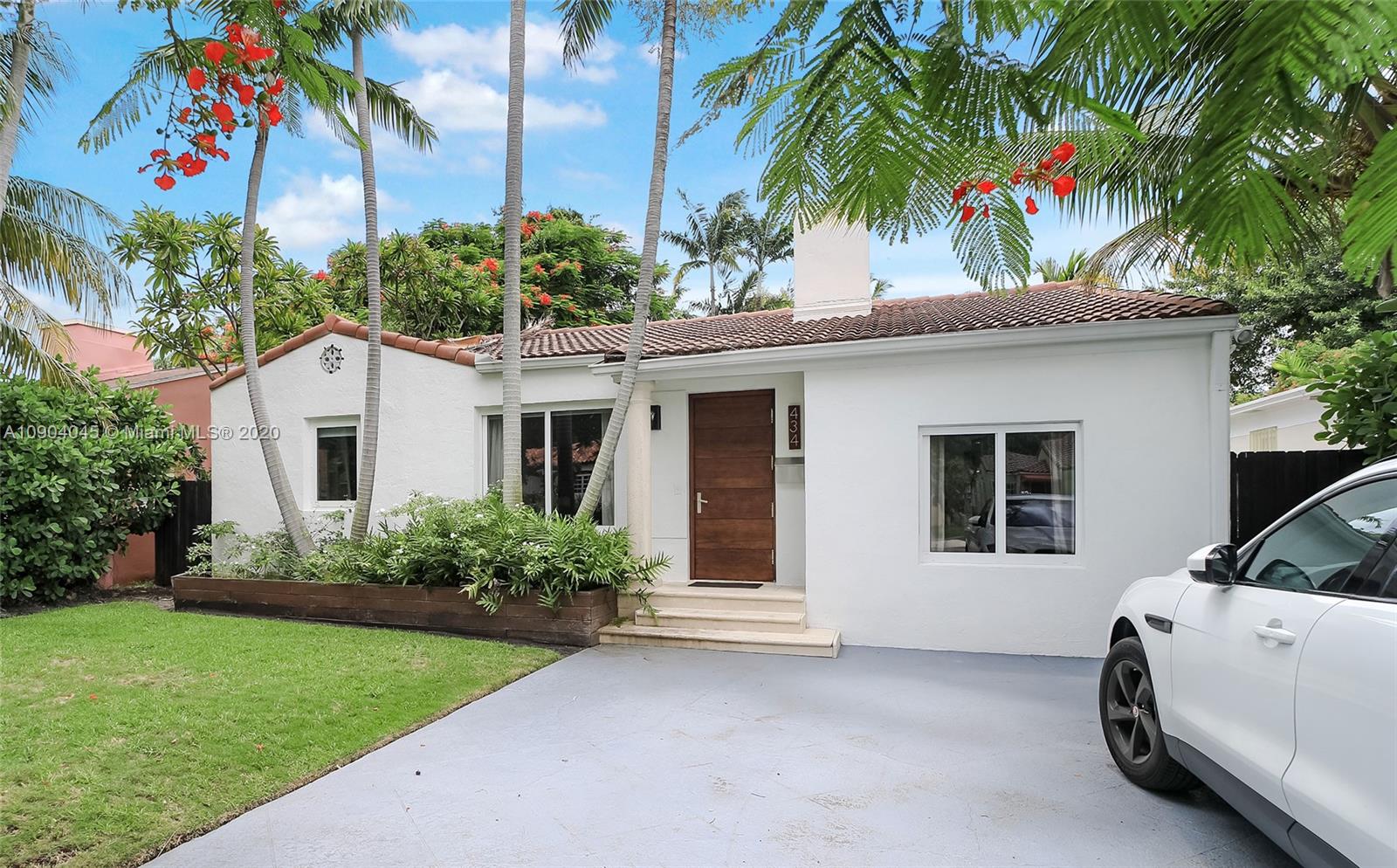 434 Southwest 30th Road Miami, FL 33129 - Photo 3 of 51 a view of a white house with a large windows and flower garden