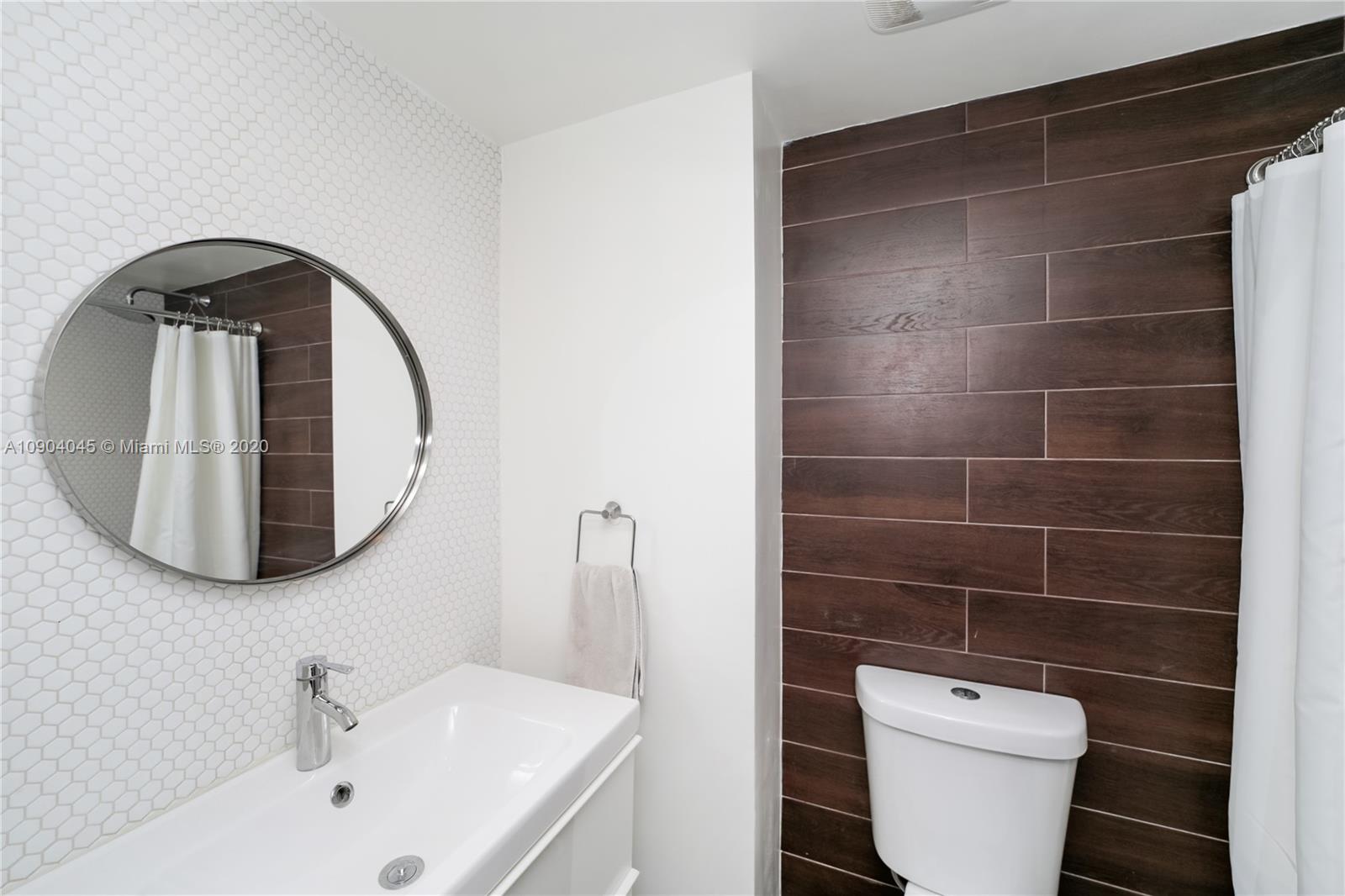 434 Southwest 30th Road Miami, FL 33129 - Photo 37 of 51 a bathroom with a toilet a sink a mirror and bathtub