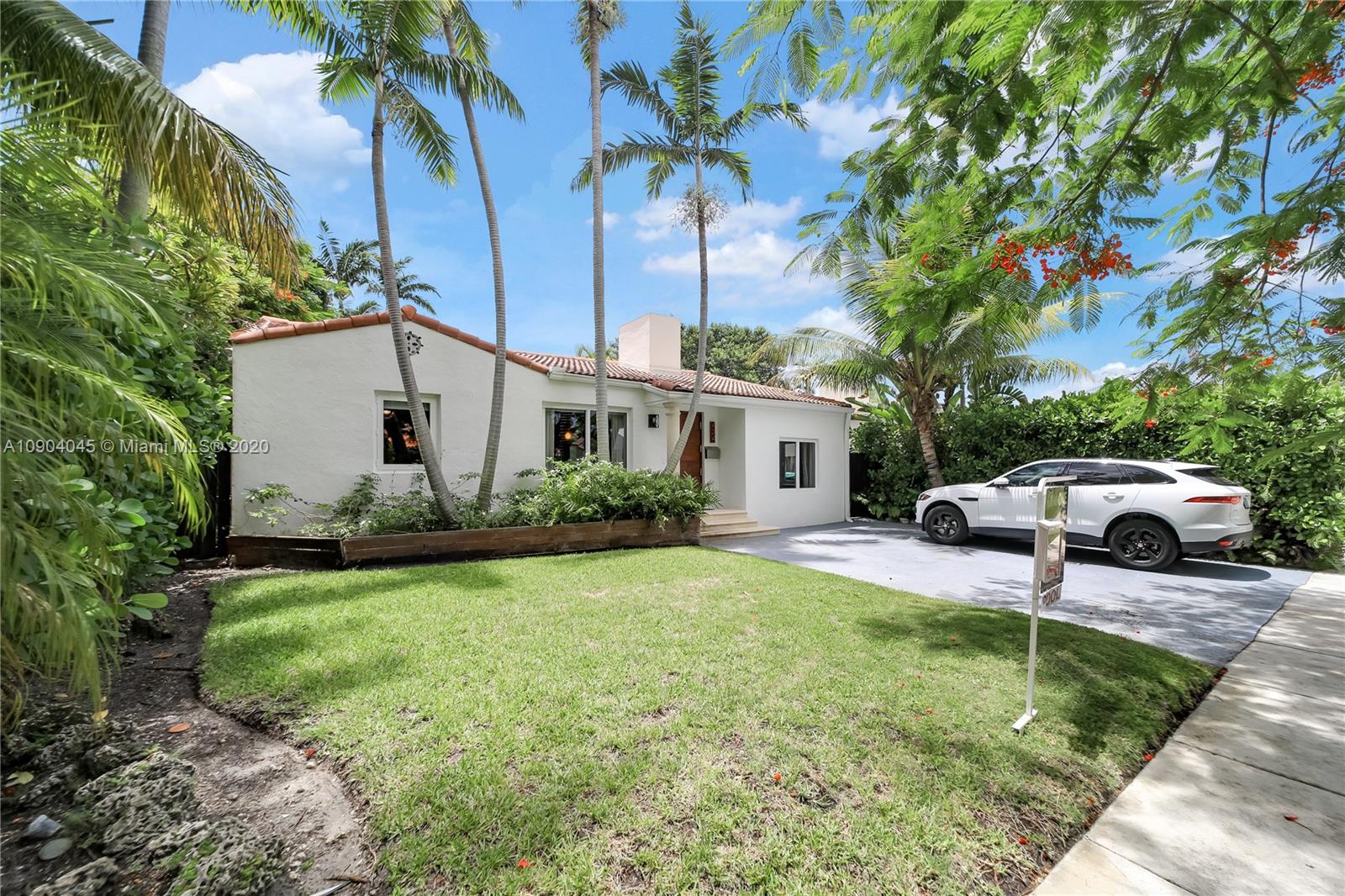 434 Southwest 30th Road Miami, FL 33129 - Photo 48 of 51 a view of a white house with a big yard and palm trees