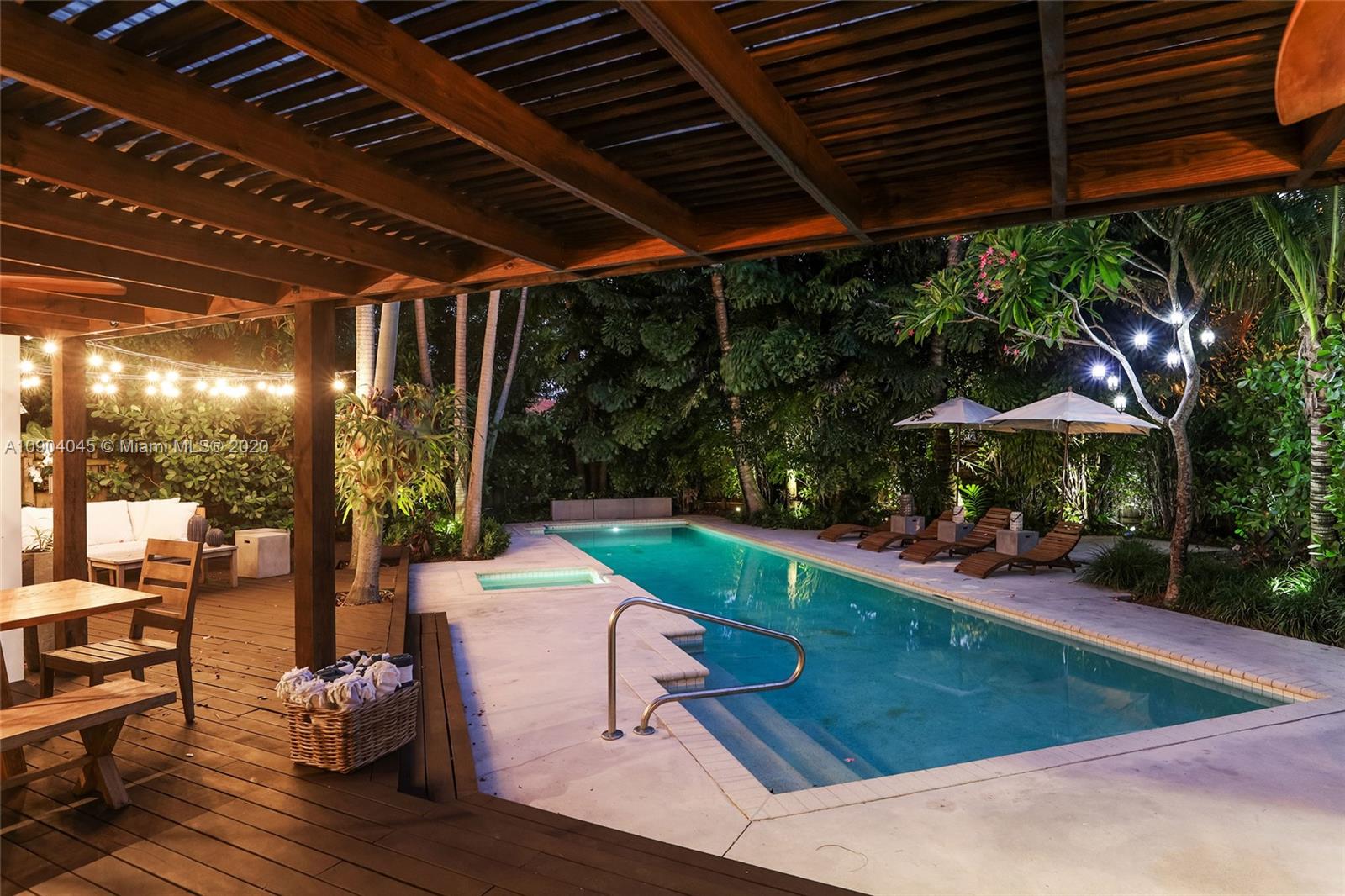 434 Southwest 30th Road Miami, FL 33129 - Photo 49 of 51 a view of a patio with table and chairs potted plants and palm trees