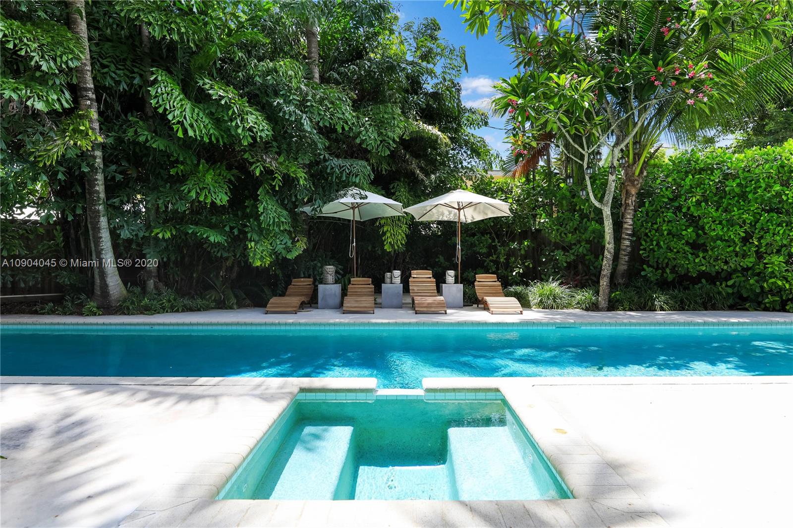 434 Southwest 30th Road Miami, FL 33129 - Photo 6 of 51 a view of pool with lawn chairs and large trees