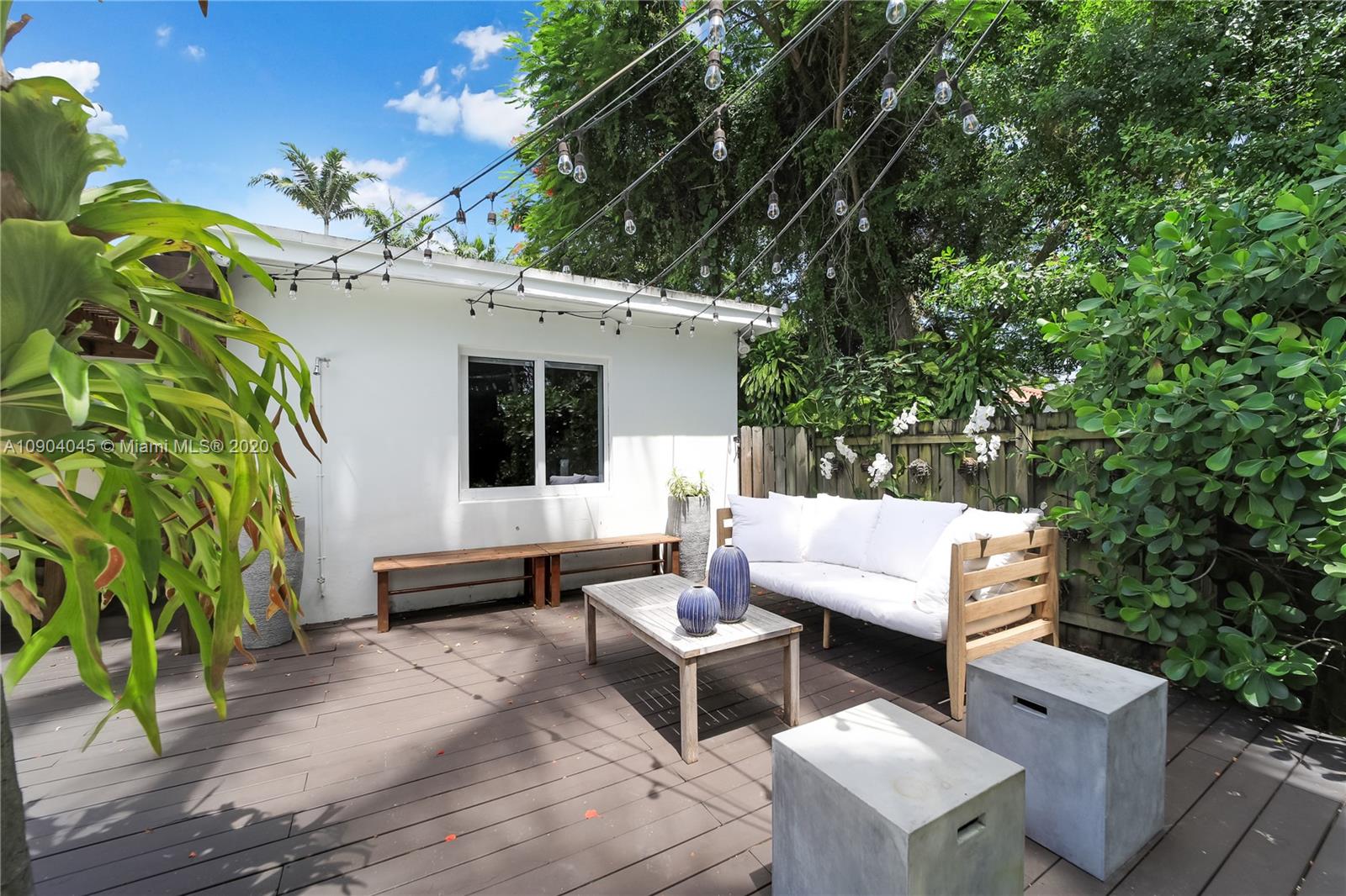 434 Southwest 30th Road Miami, FL 33129 - Photo 10 of 51 a view of a patio with table and chairs with potted plants and large trees