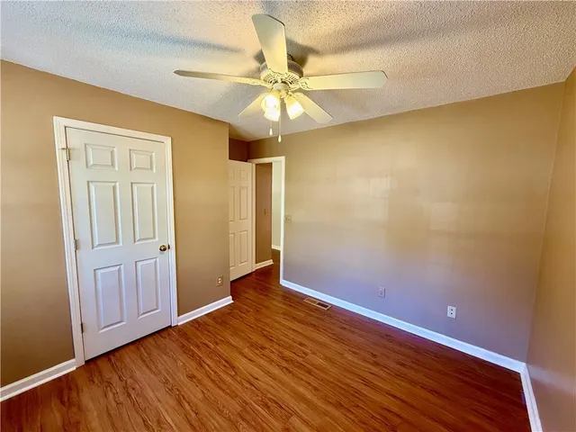 a view of a room with wooden floor and natural light