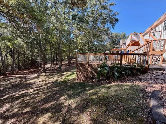 a view of yard with swimming pool and green space