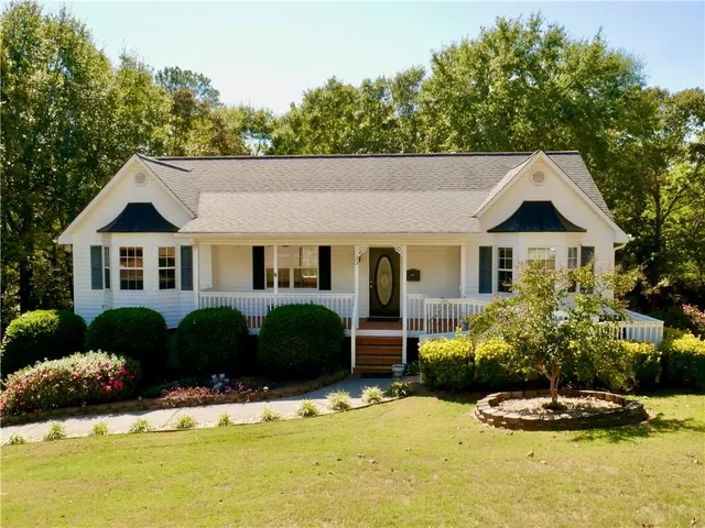 a front view of a house with a garden