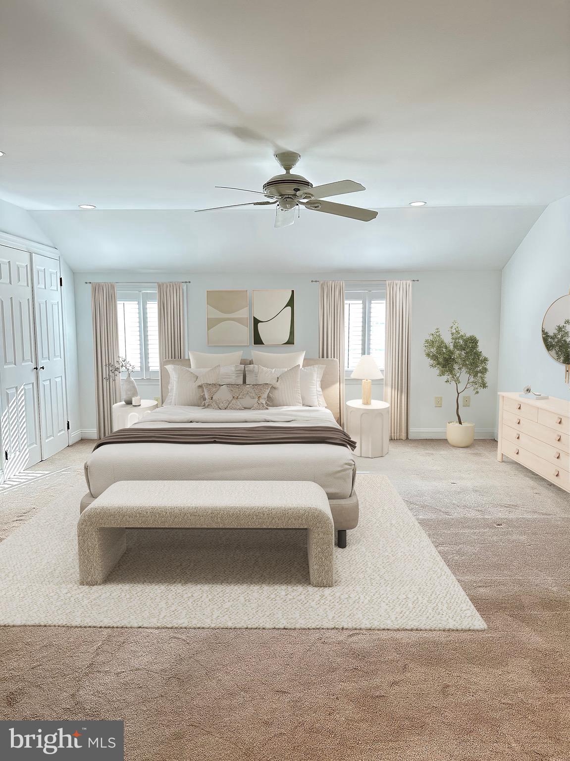a spacious bedroom with a large bed and ceiling fan