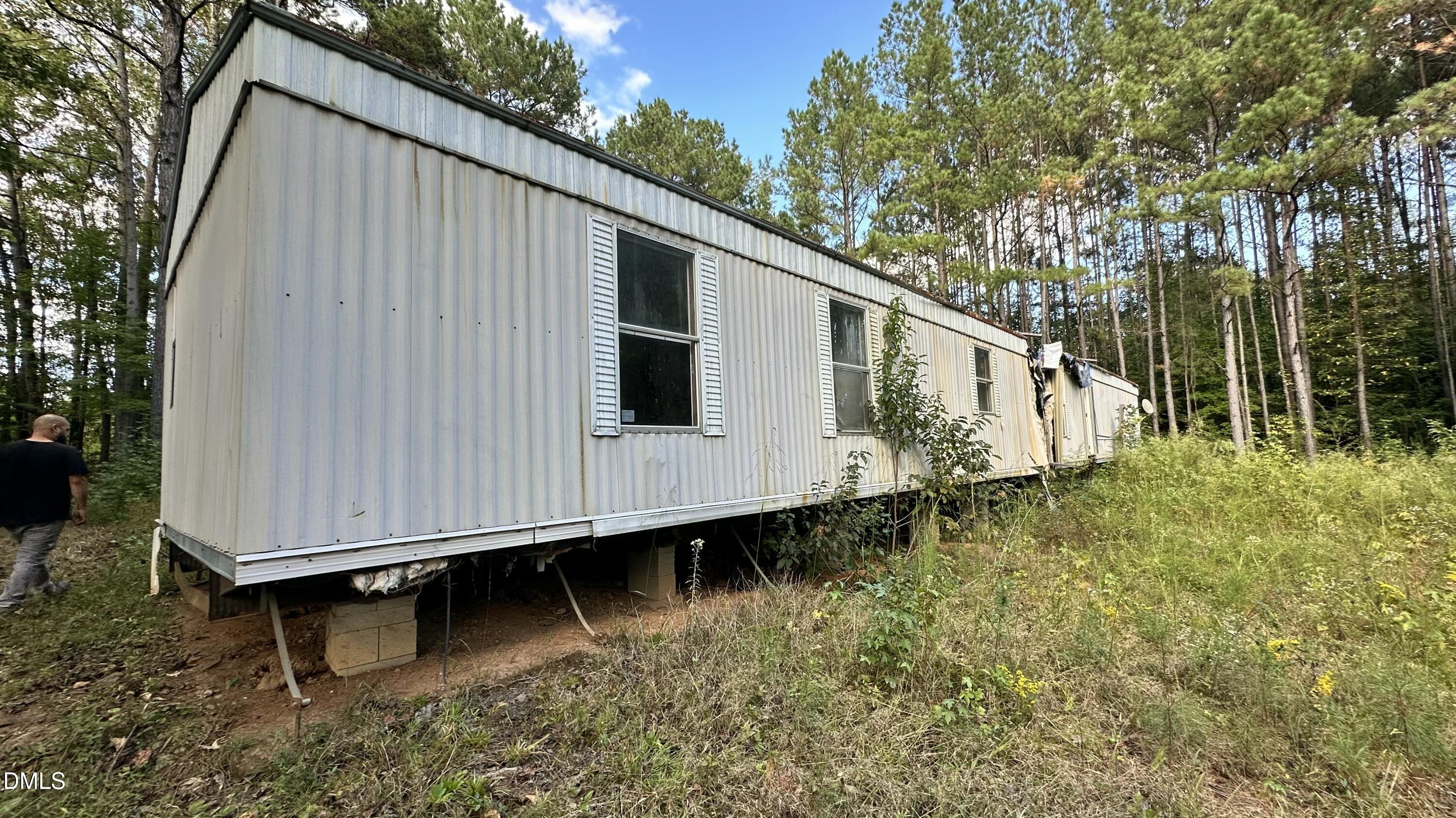 1539 Schloss Road Louisburg, NC 27549 - Photo 3 of 10 a backyard of a house with large trees and wooden fence