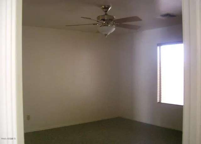 a kitchen with granite countertop white cabinets and black appliances