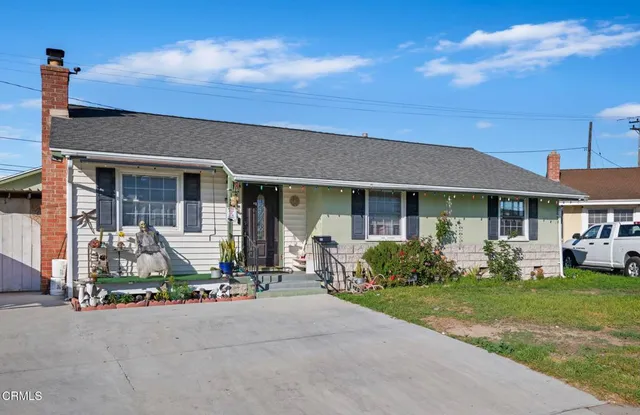 a front view of a house with garden and porch