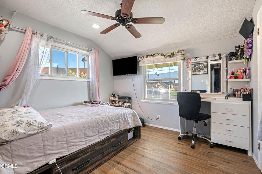 145 Homer Street Oxnard, CA 93033 - Photo 11 of 15 a bedroom with a bed a flat screen tv and a window