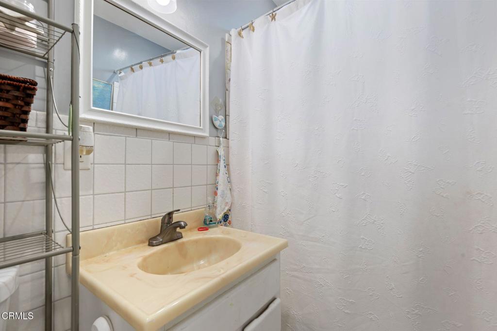 145 Homer Street Oxnard, CA 93033 - Photo 12 of 15 a bathroom with a sink and a mirror