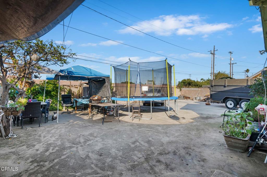 145 Homer Street Oxnard, CA 93033 - Photo 15 of 15 a view of a patio with dining table and chairs under an umbrella