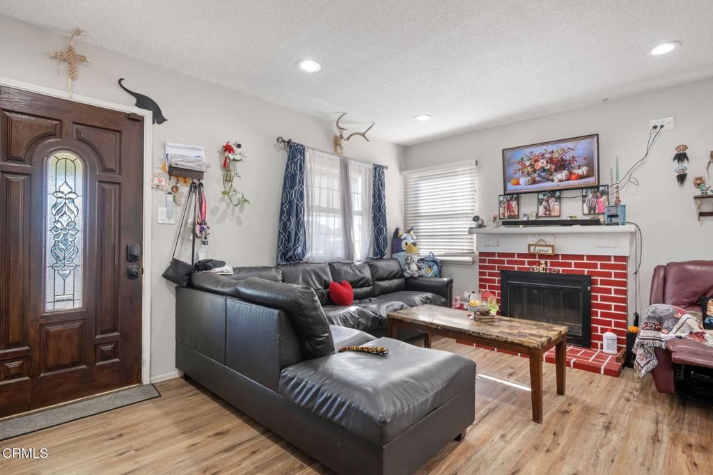 145 Homer Street Oxnard, CA 93033 - Photo 3 of 15 a living room with furniture and a fireplace