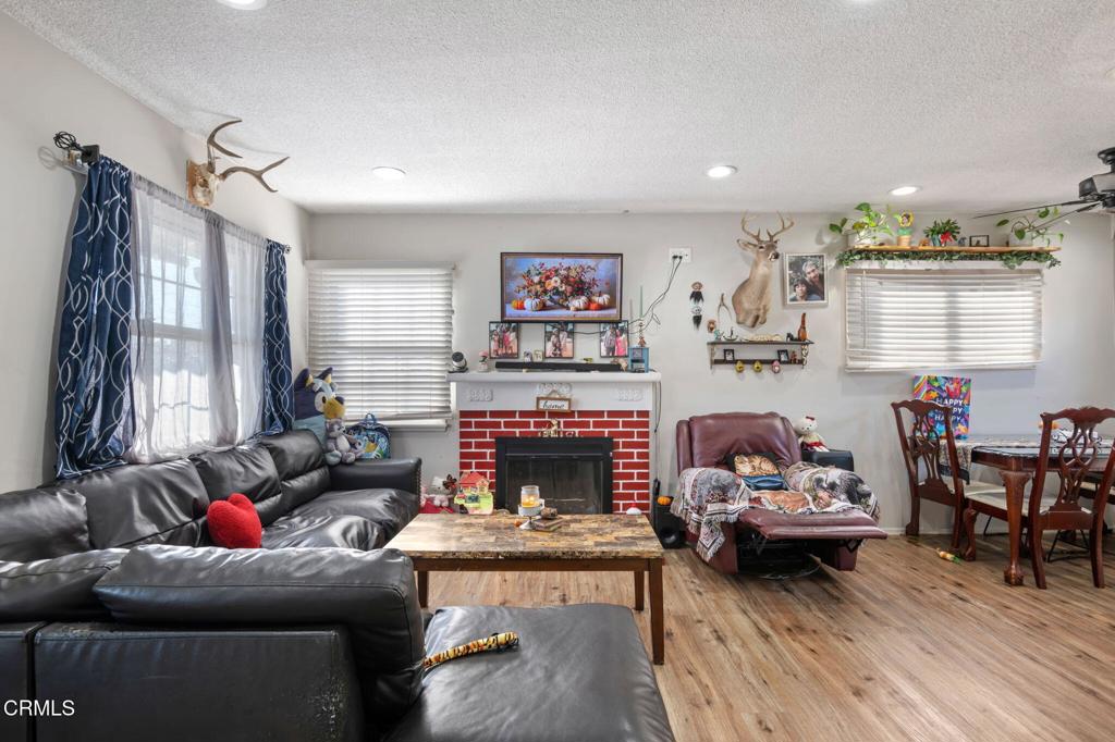 145 Homer Street Oxnard, CA 93033 - Photo 4 of 15 a living room with furniture and a fireplace