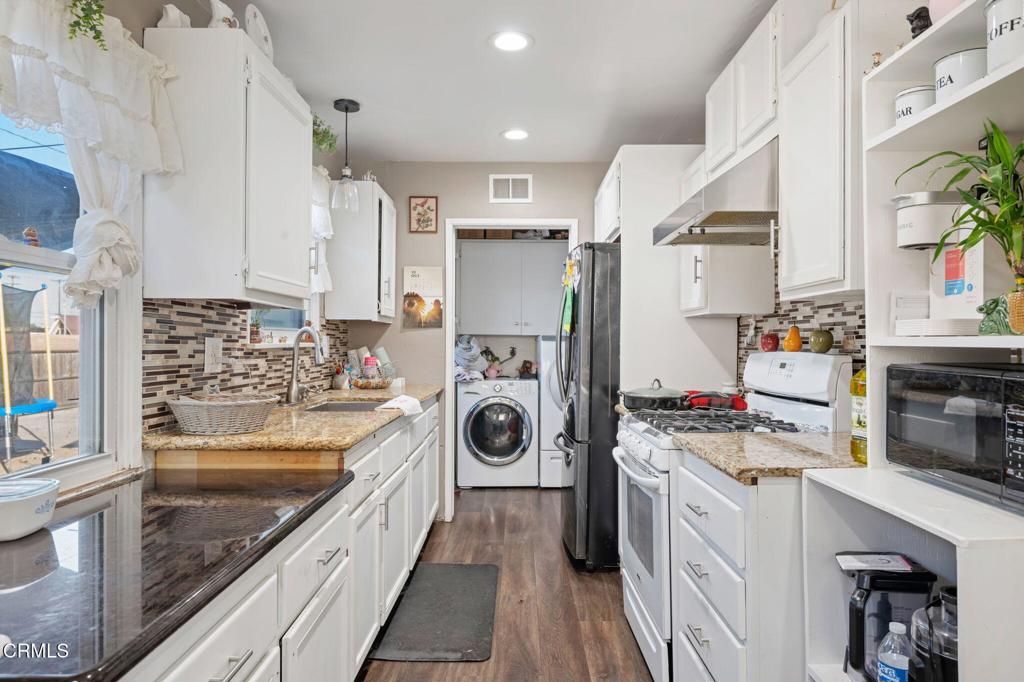 145 Homer Street Oxnard, CA 93033 - Photo 7 of 15 a kitchen with stainless steel appliances granite countertop a stove and a sink