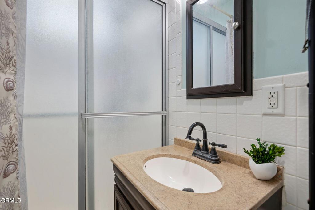 145 Homer Street Oxnard, CA 93033 - Photo 10 of 15 a bathroom with a sink and a mirror