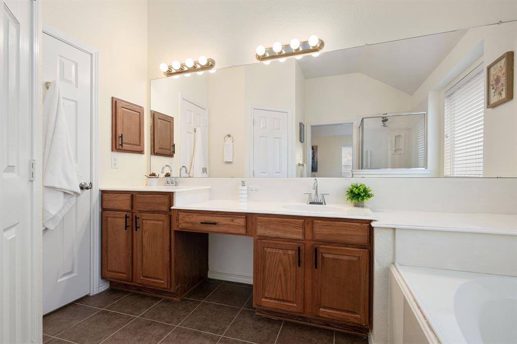 10210 Bent Tree Drive Rowlett, TX 75089 - Photo 13 of 27 a kitchen with kitchen island granite countertop a sink and cabinets