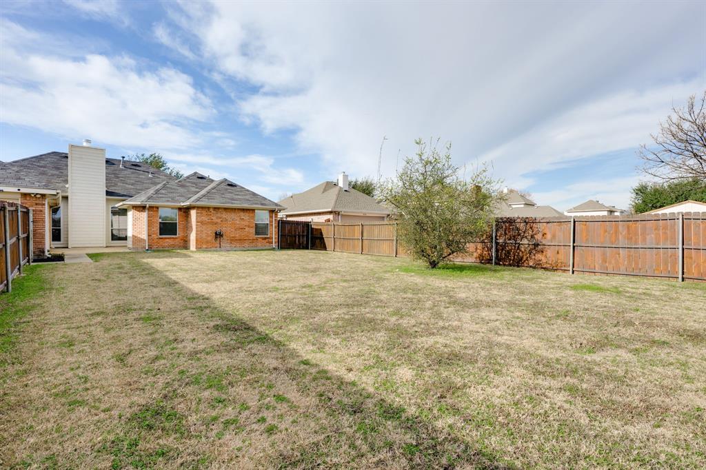 10210 Bent Tree Drive Rowlett, TX 75089 - Photo 22 of 27 a big house with a big yard and large trees