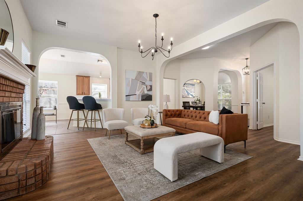 10210 Bent Tree Drive Rowlett, TX 75089 - Photo 3 of 27 a living room with furniture and a chandelier