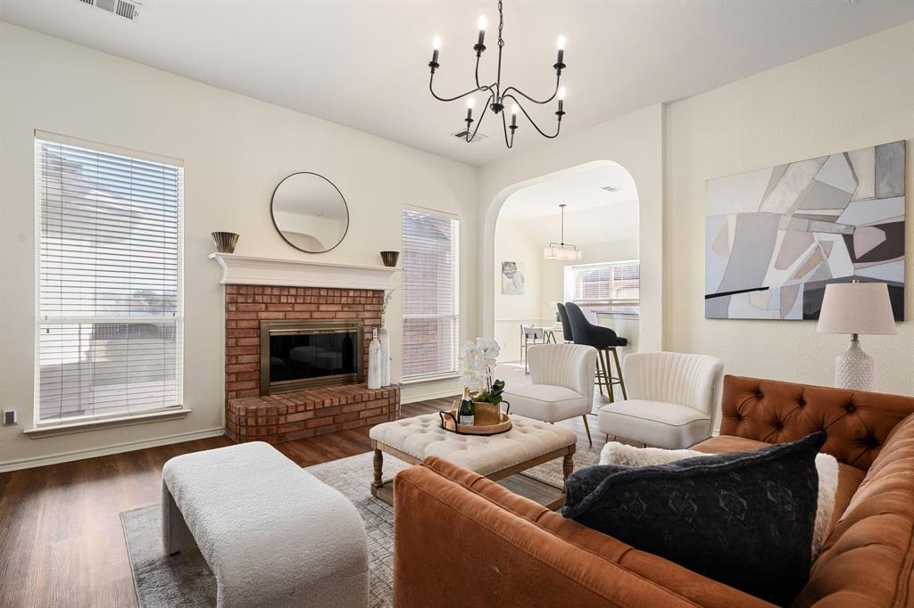 10210 Bent Tree Drive Rowlett, TX 75089 - Photo 4 of 27 a living room with furniture a fireplace and wooden floor