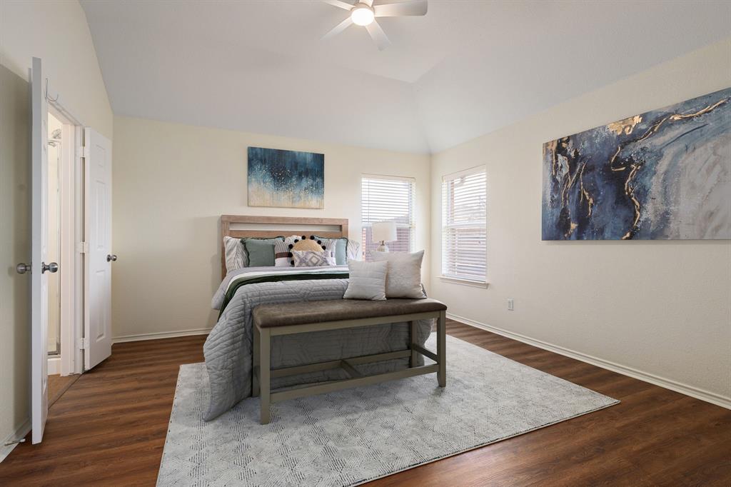 10210 Bent Tree Drive Rowlett, TX 75089 - Photo 10 of 27 a bedroom with a bed and wooden floor