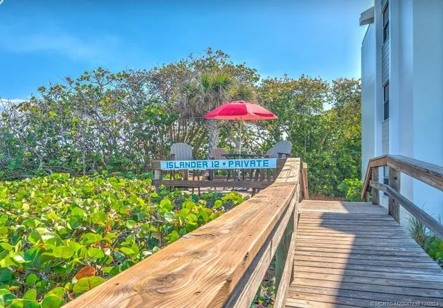 a view of a balcony with wooden floor and fence