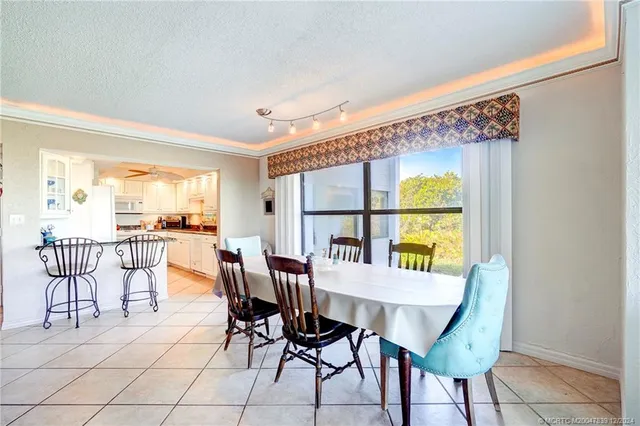 a view of a dining room with furniture and a table and chairs