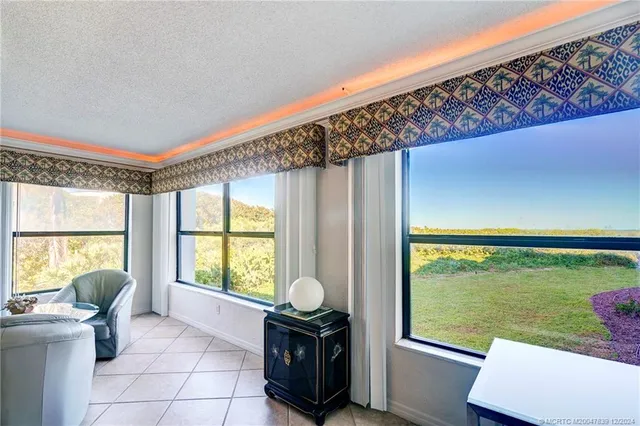 a living room with a large window and yard