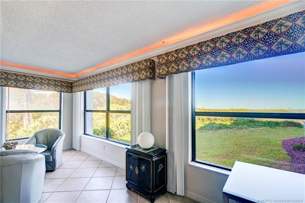 1289 Northeast Ocean Boulevard, Unit 2 Stuart, FL 34996 - Photo 15 of 41 a living room with a large window and yard