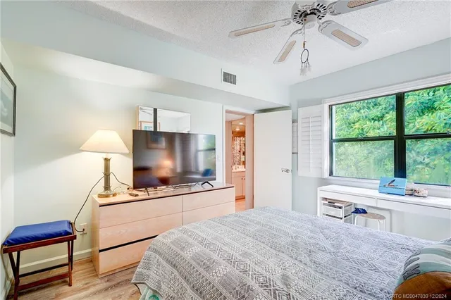 a room with a bed and a flat screen tv