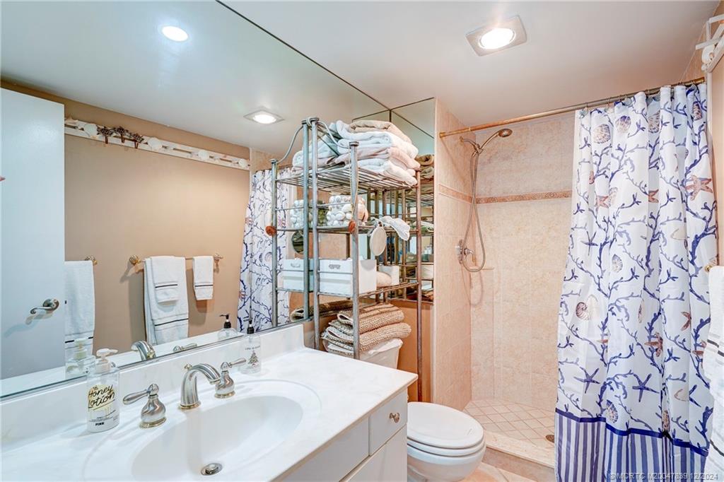 1289 Northeast Ocean Boulevard, Unit 2 Stuart, FL 34996 - Photo 21 of 41 a bathroom with a sink toilet and shower