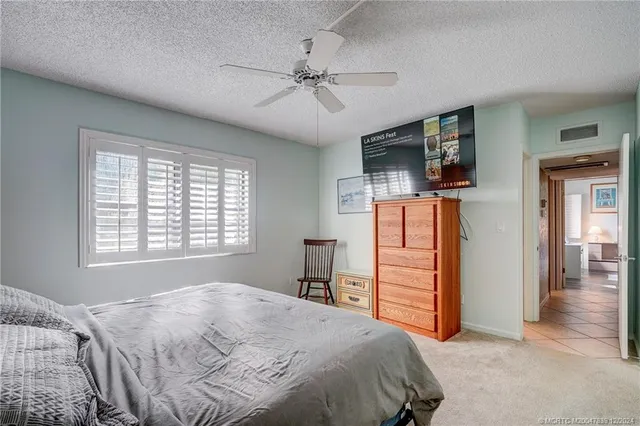 a bedroom with a bed and a television