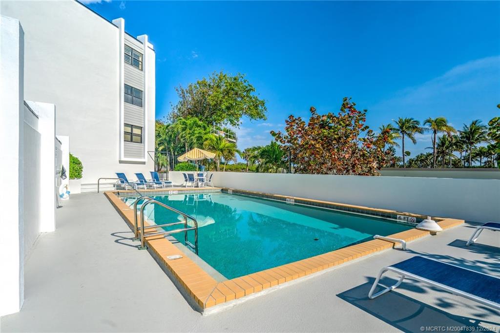 1289 Northeast Ocean Boulevard, Unit 2 Stuart, FL 34996 - Photo 30 of 41 swimming pool with chairs