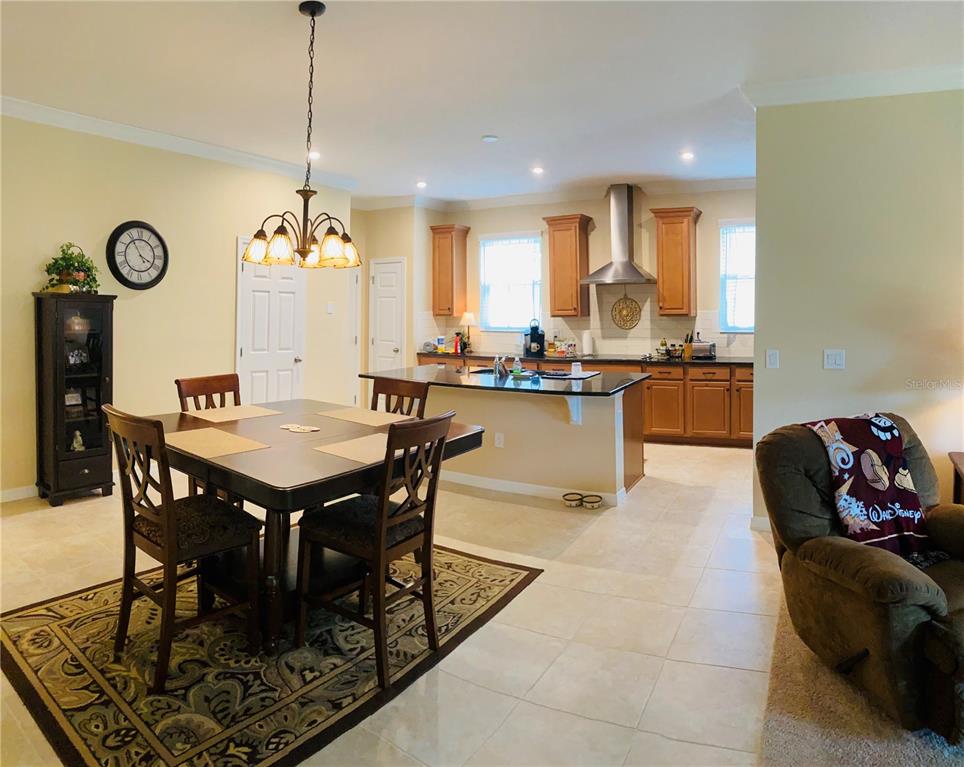 2337 Farnham Drive Ocoee, FL 34761 - Photo 2 of 20 a view of a dining room and livingroom view with furniture wooden floor a rug a chandelier and a view