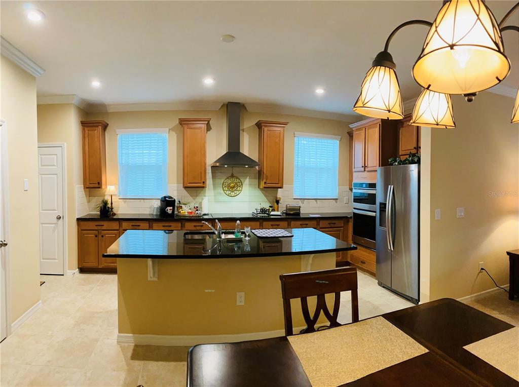 2337 Farnham Drive Ocoee, FL 34761 - Photo 5 of 20 a large kitchen with stainless steel appliances granite countertop a sink a stove and a refrigerator