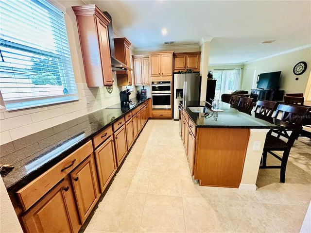 a view of a kitchen with kitchen island dining table and chairs