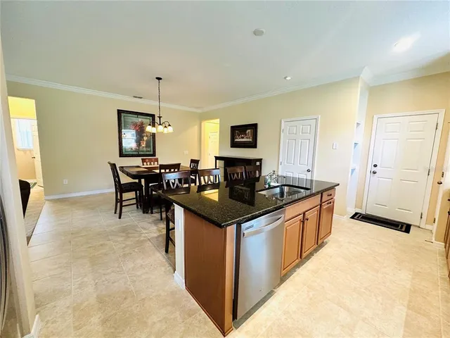 a kitchen with granite countertop a sink and a stove top oven