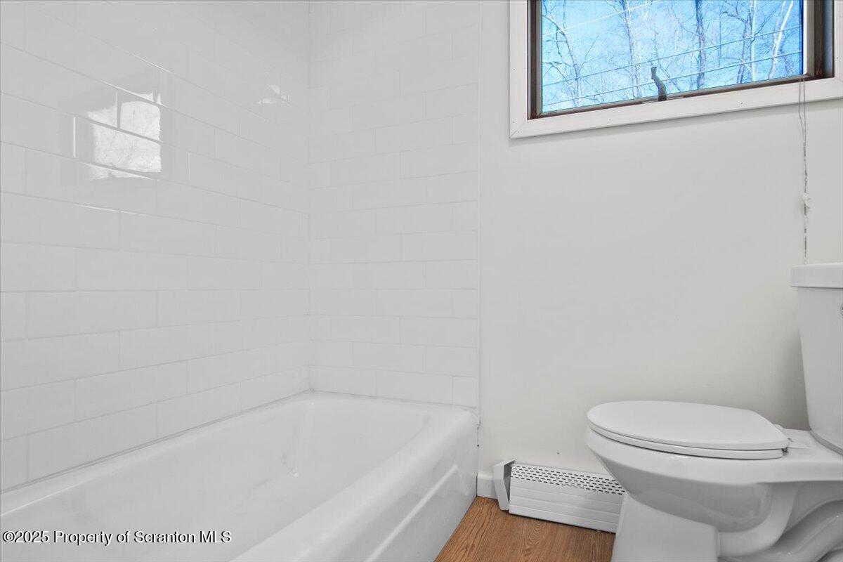 134 Lampman Street Avoca, PA 18641 - Photo 14 of 34 a bathroom with a toilet and bathtub