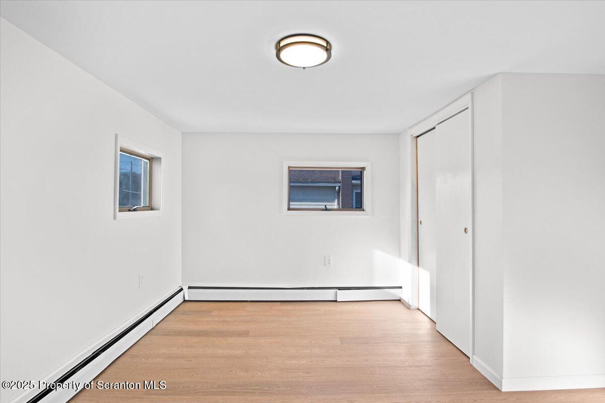 134 Lampman Street Avoca, PA 18641 - Photo 19 of 34 a view of a room with wooden floor and window