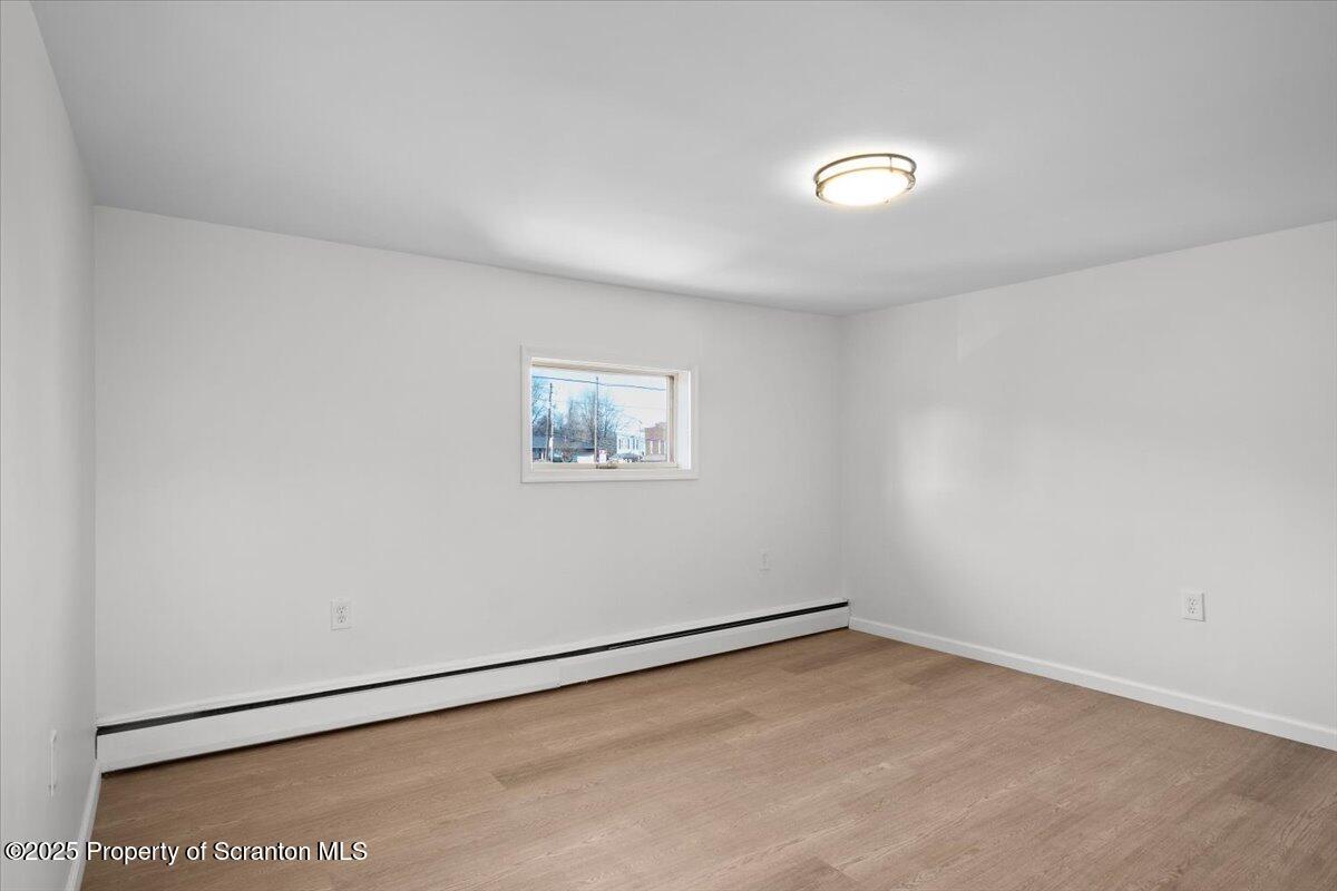 134 Lampman Street Avoca, PA 18641 - Photo 21 of 34 an empty room with a workbench