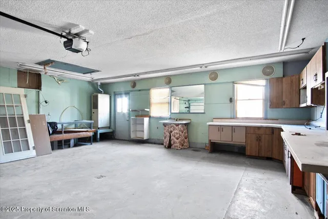 a kitchen with a sink and a stove top oven