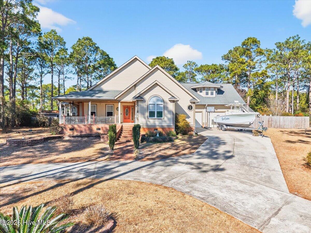 Beautiful custom-built home with inviting curb appeal, circular driveway, and spacious 0.8-acre lot in Brierwood Estates.