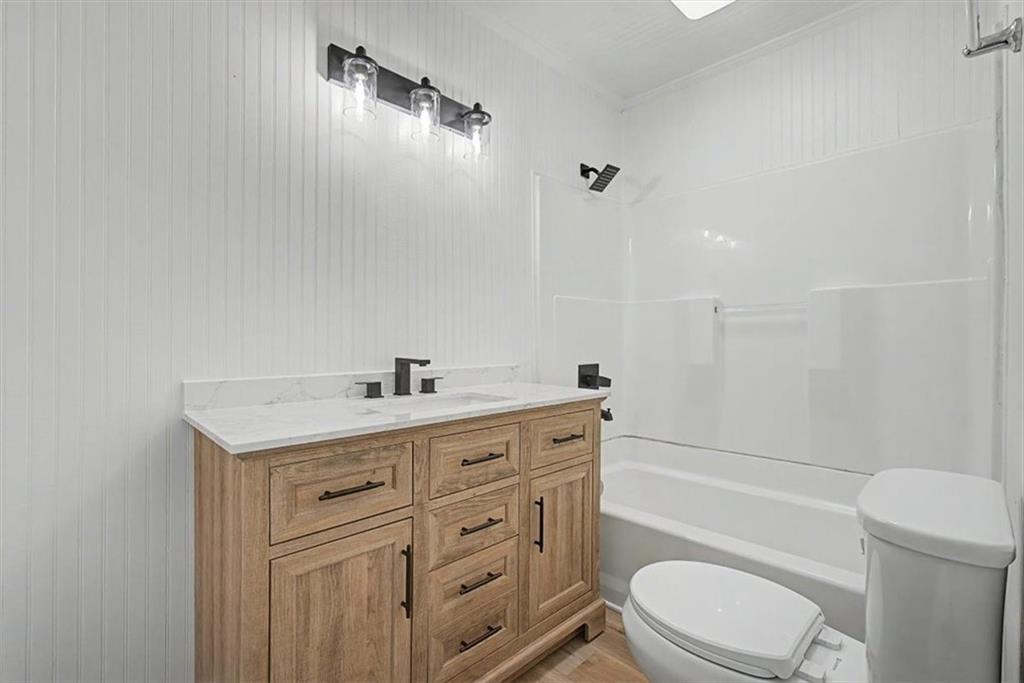 2115 King Road Dalton, GA 30720 - Photo 30 of 54 a bathroom with a granite countertop toilet sink and mirror